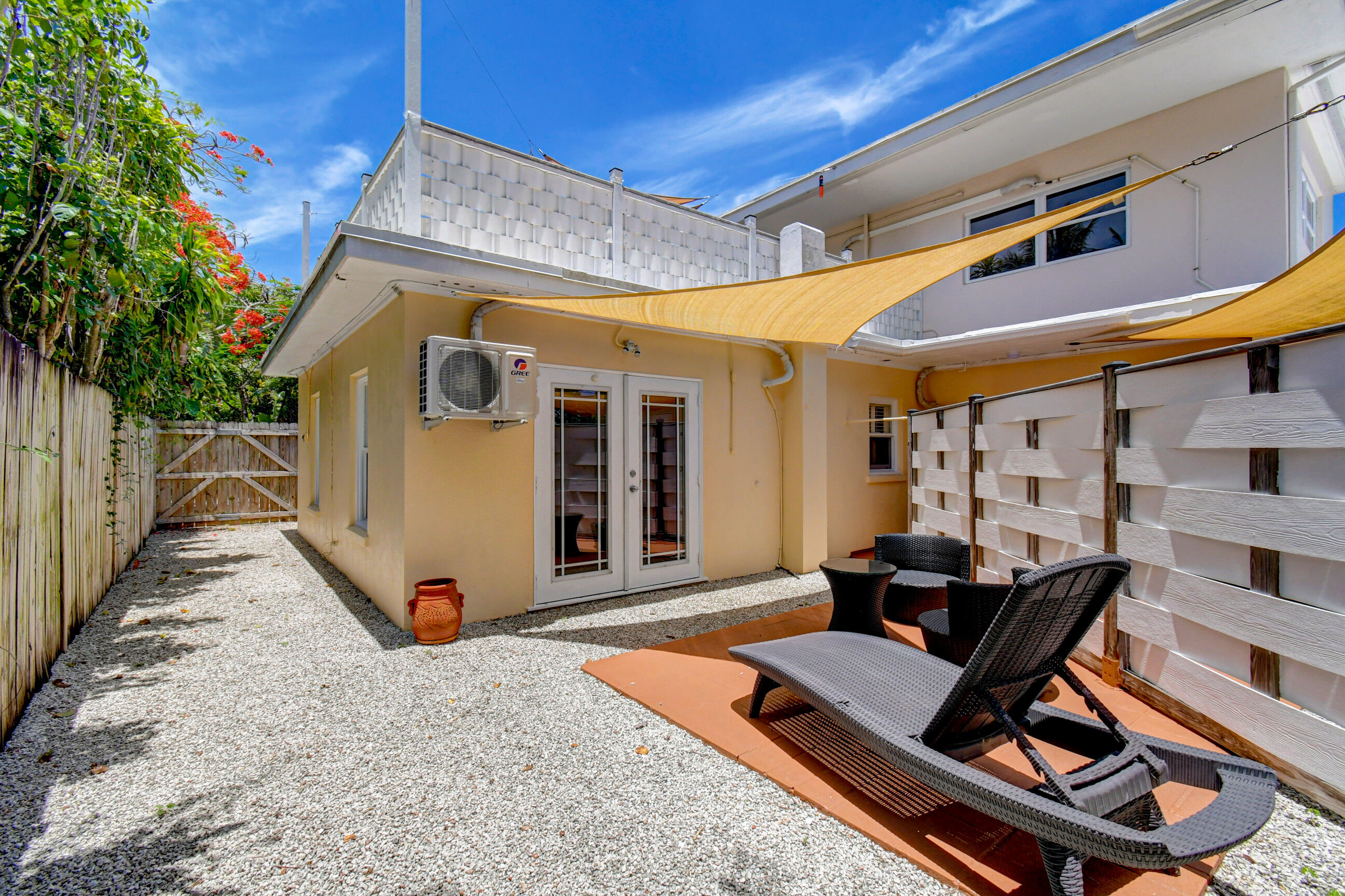 4 Gibbs Road, Unit 1 Boynton Beach, FL 33435 - Photo 30 of 43 a roof deck with table and chairs and potted plants