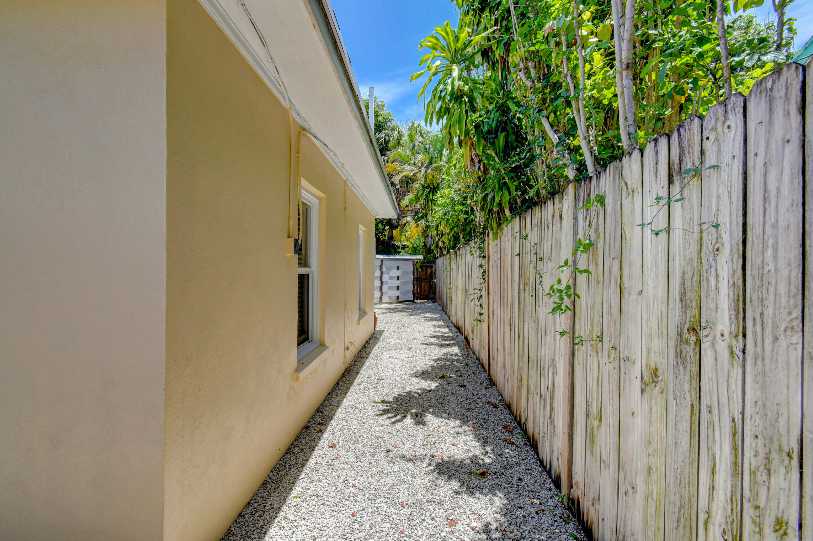 4 Gibbs Road, Unit 1 Boynton Beach, FL 33435 - Photo 35 of 43 a view of a pathway of a house with wooden fence