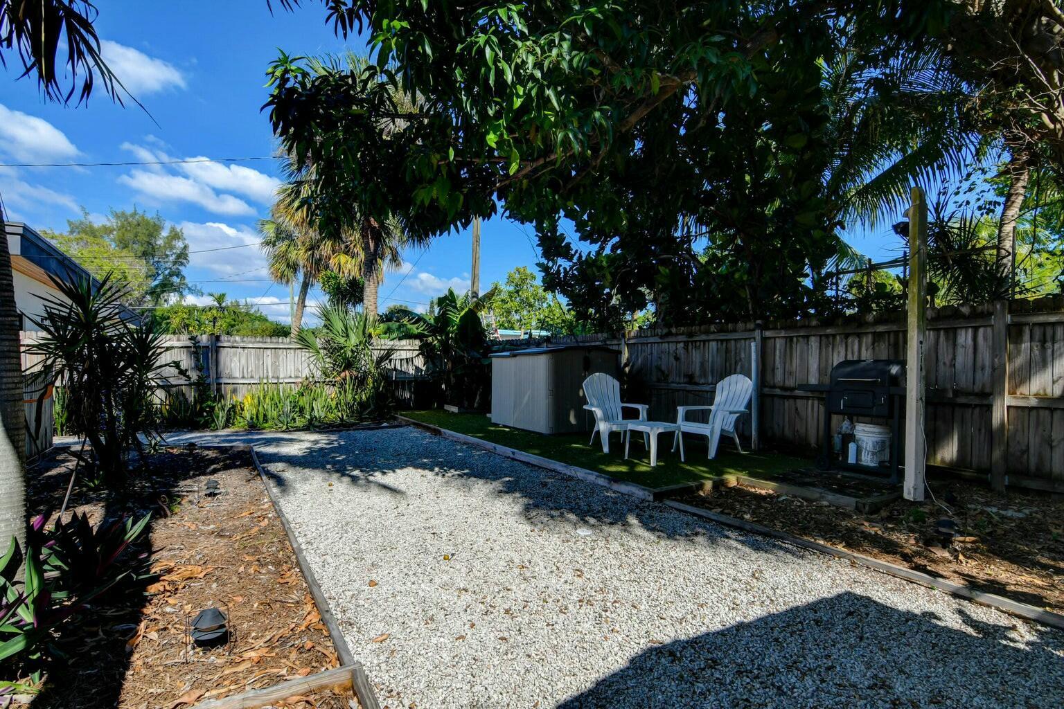 4 Gibbs Road, Unit 1 Boynton Beach, FL 33435 - Photo 42 of 43 a view of a backyard with sitting area and furniture