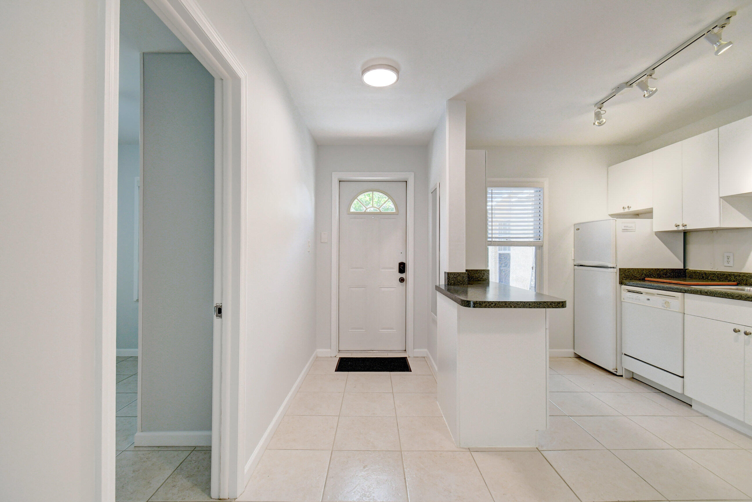 4 Gibbs Road, Unit 1 Boynton Beach, FL 33435 - Photo 5 of 43 a large white kitchen with a sink