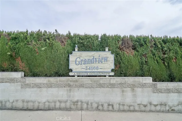 a sign that is sitting on a brick wall