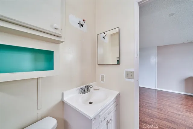 a bathroom with a toilet sink and mirror