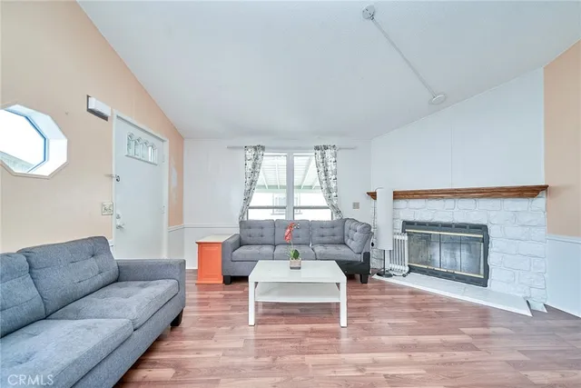a living room with furniture a window and a fireplace