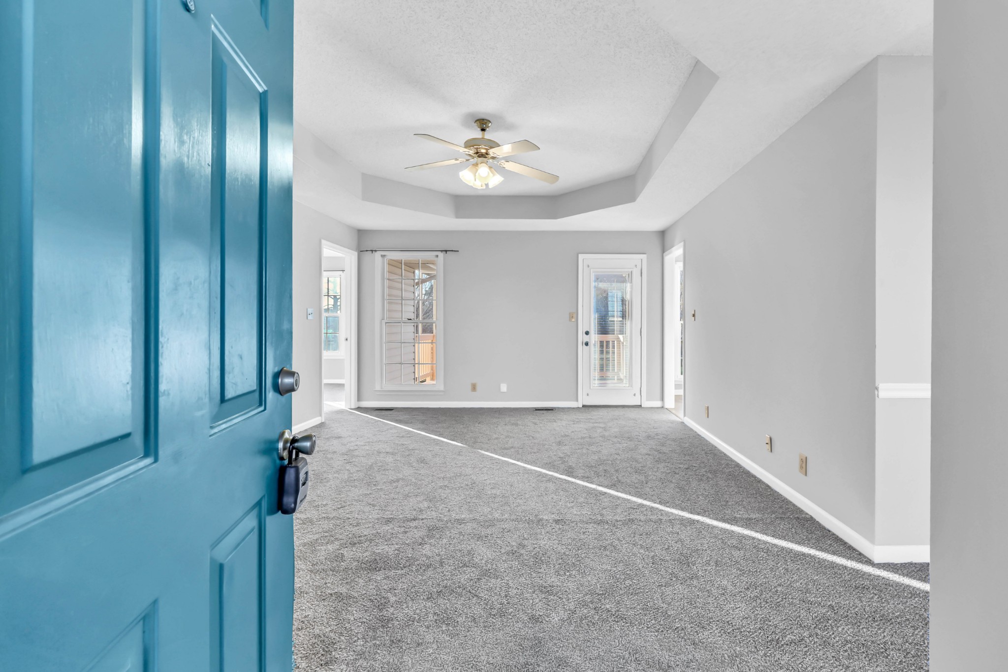 3708 Trenton Road Clarksville, TN 37042 - Photo 8 of 35 an empty room with chandelier fan and windows
