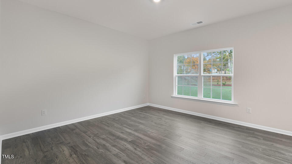 73 Stone Apiary Drive Angier, NC 27501 - Photo 13 of 32 an empty room with wooden floor and windows