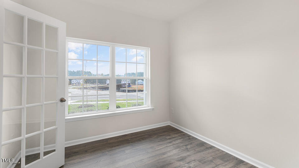 73 Stone Apiary Drive Angier, NC 27501 - Photo 4 of 32 a view of an empty room with wooden floor and a window