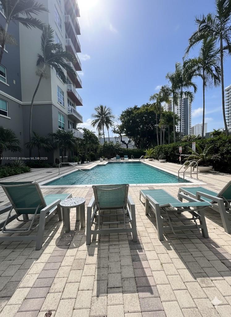 313 Northeast 2nd Street, Unit 802 Fort Lauderdale, FL 33301 - Photo 2 of 12 a view of a swimming pool with lounge chair in the patio