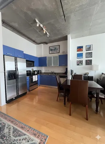 a living room with stainless steel appliances kitchen island granite countertop furniture and a kitchen view