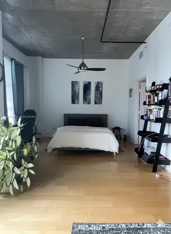 a bedroom with furniture and a chandelier