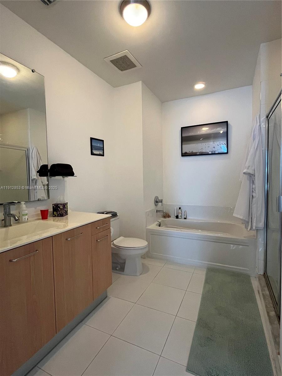 313 Northeast 2nd Street, Unit 802 Fort Lauderdale, FL 33301 - Photo 10 of 12 a bathroom with a bathtub sink mirror and toilet