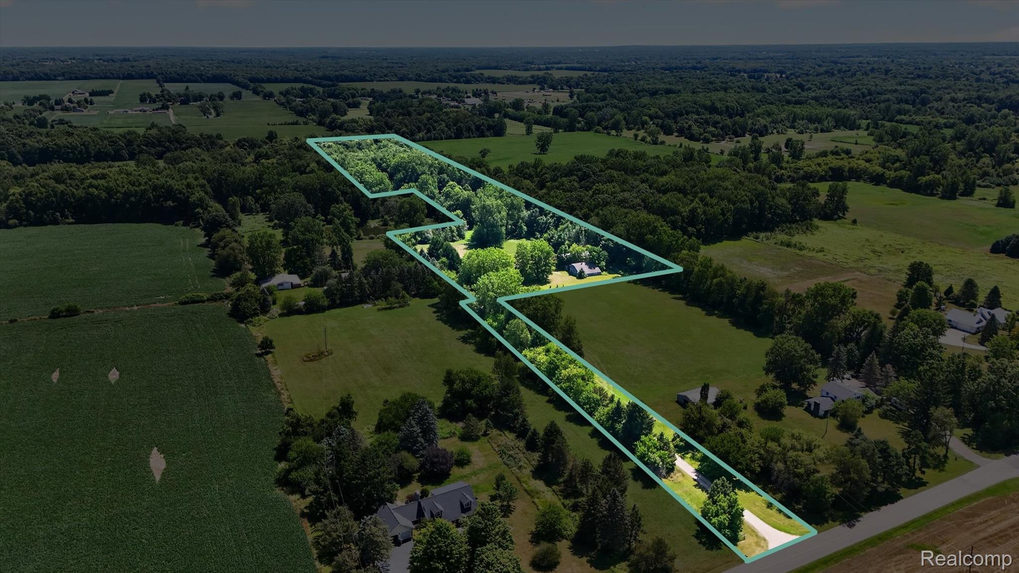 3760 Webberville Road North Williamston, MI 48895 - Photo 76 of 80 Expansive rural property featuring distinctive linear architectural design with integrated green spaces, mature tree canopy throughout the grounds, and substantial acreage with manicured lawn areas