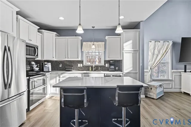 a kitchen with stainless steel appliances granite countertop a sink refrigerator and microwave