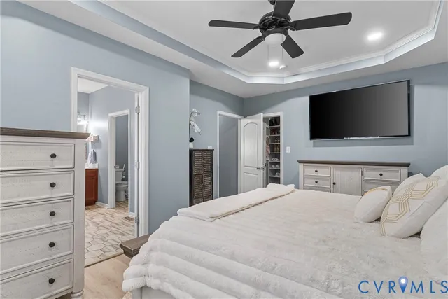 a spacious bedroom with a bed and a chandelier