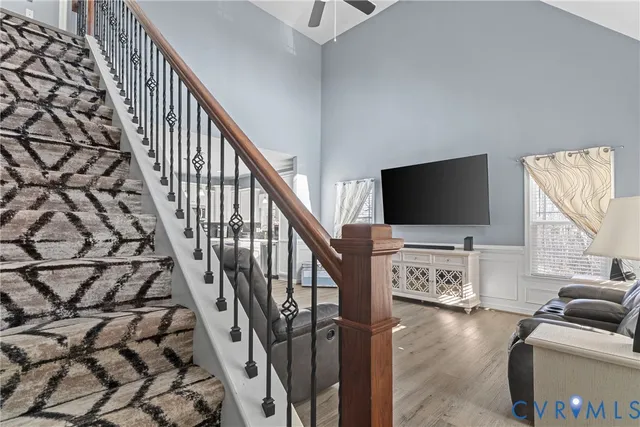 a living room with chairs and a flat screen tv