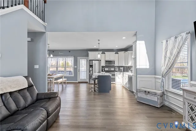a living room with furniture and a kitchen view