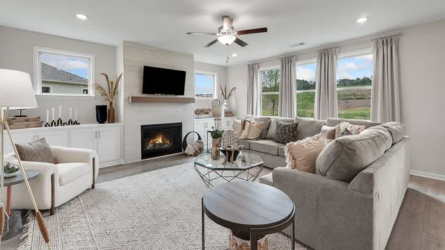 a kitchen with stainless steel appliances a refrigerator a stove a sink dishwasher a dining table and chairs with wooden floor