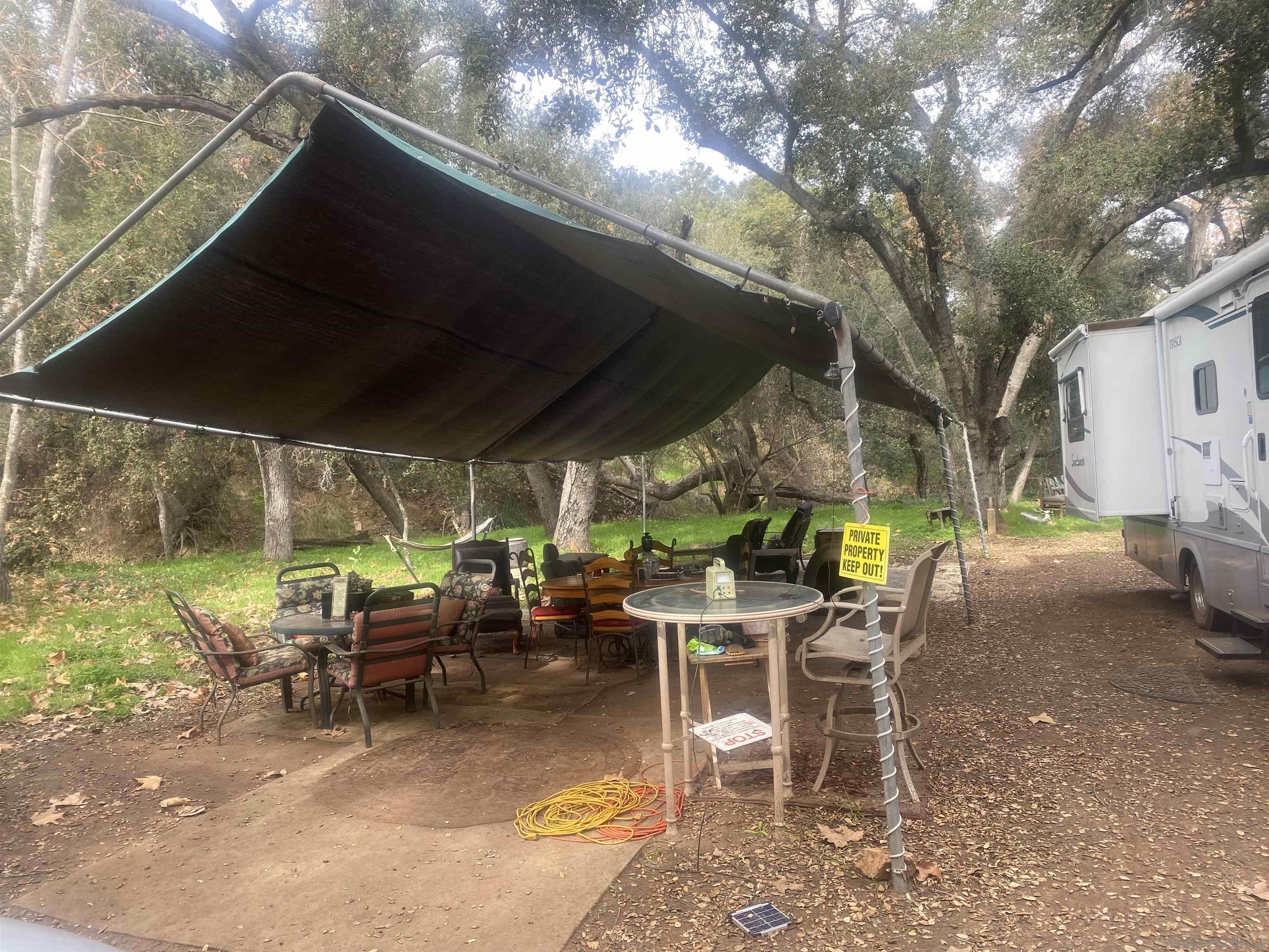 9 Lilac Road Valley Center, CA 92082 - Photo 20 of 27 a view of a patio with table and chairs under an umbrella