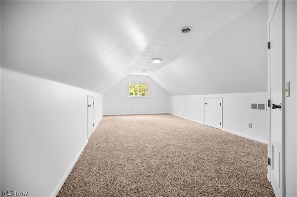 28300 Aurora Road Solon, OH 44139 - Photo 21 of 36 Spacious attic room featuring sloped ceilings, recessed lighting, and a neutral carpet