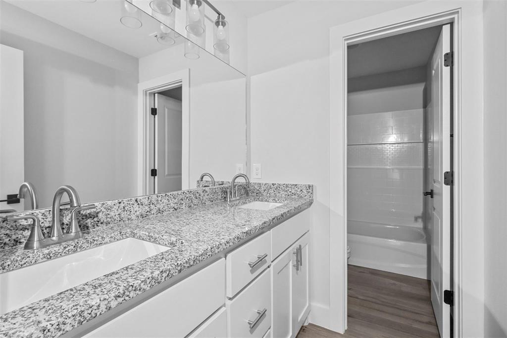 408 West 6th Street, Unit 2 Bonham, TX 75418 - Photo 11 of 16 a bathroom with a sink and a mirror