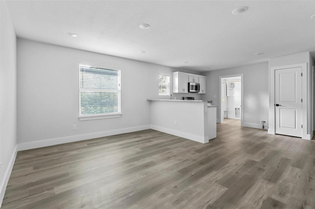 408 West 6th Street, Unit 2 Bonham, TX 75418 - Photo 2 of 16 a view of a kitchen with wooden floor electronic appliances and window