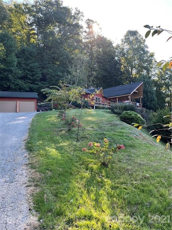 44 Emerald Mountain Road Clyde, NC 28721 - Photo 2 of 33 a backyard of a house with lots of green space