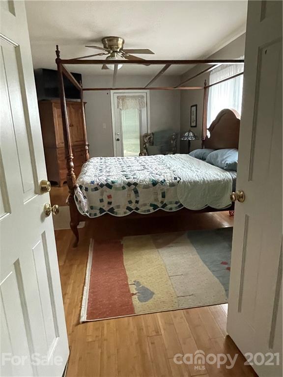 44 Emerald Mountain Road Clyde, NC 28721 - Photo 14 of 33 a bedroom with a bed and a mirror