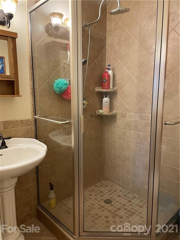 44 Emerald Mountain Road Clyde, NC 28721 - Photo 22 of 33 a bathroom with a sink toilet and shower
