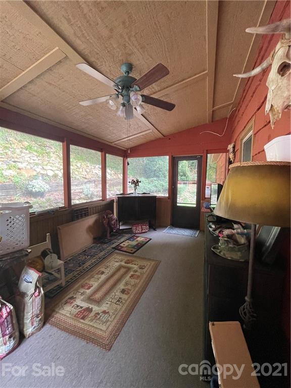 44 Emerald Mountain Road Clyde, NC 28721 - Photo 25 of 33 a living room with furniture a window and a flat screen tv