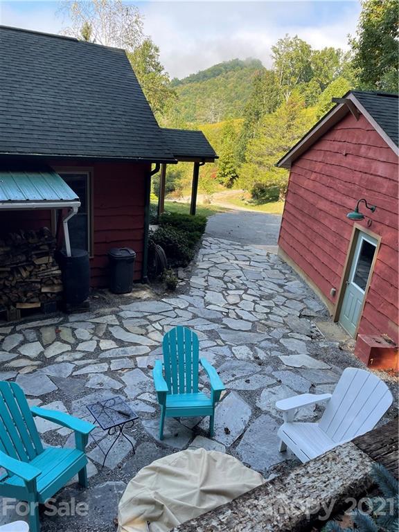 44 Emerald Mountain Road Clyde, NC 28721 - Photo 26 of 33 a view of a backyard with table and chairs potted plants