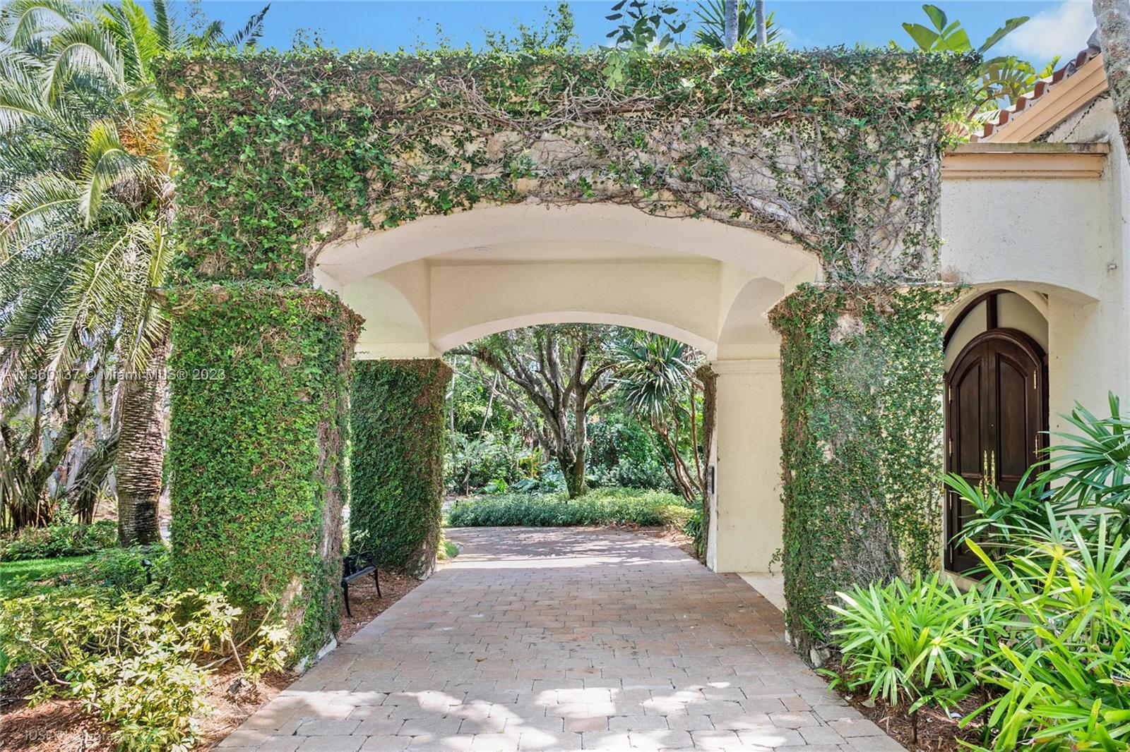 6850 Southwest 115th Street Pinecrest, FL 33156 - Photo 1 of 39 a view of a garden with a fountain