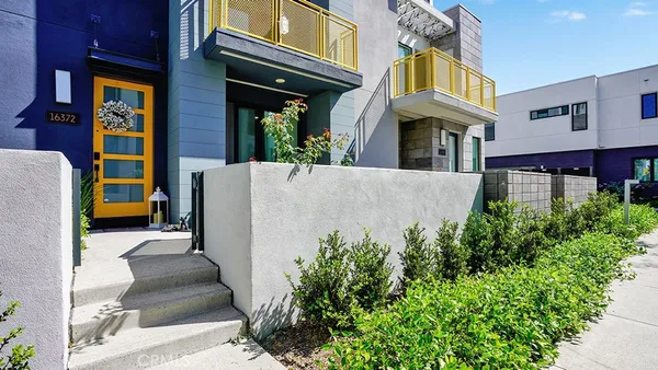 a view of a hallway with wooden floor and entryway