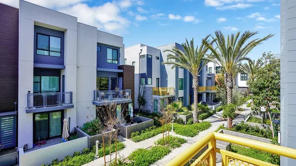 a swimming pool with outdoor seating and plants
