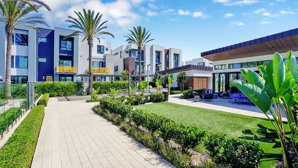 a view of a patio with table and chairs potted plants and palm trees