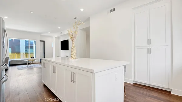 a kitchen with stainless steel appliances a refrigerator and a stove top oven