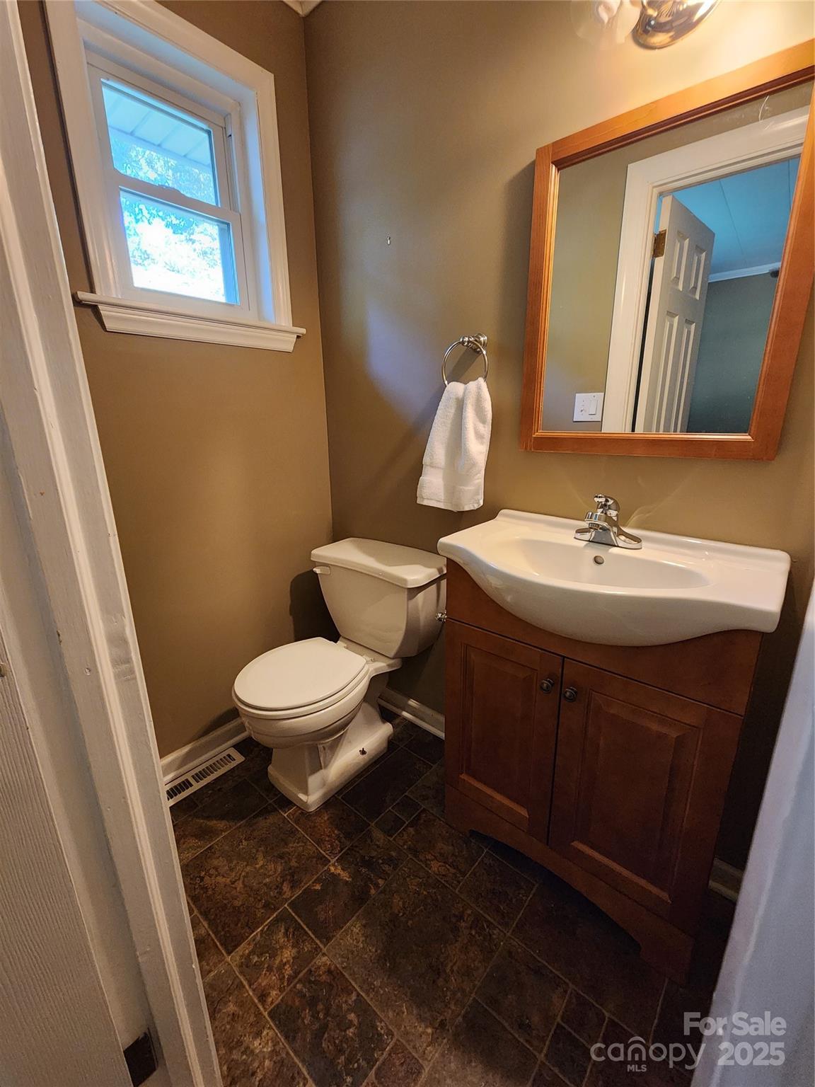 148 Palaside Drive Northeast Concord, NC 28025 - Photo 12 of 17 a bathroom with a toilet sink and mirror