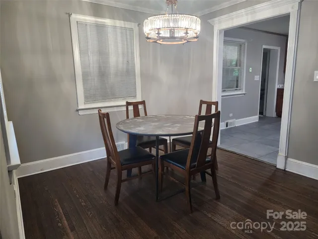 a view of a dining room with furniture wooden floor and chandelier