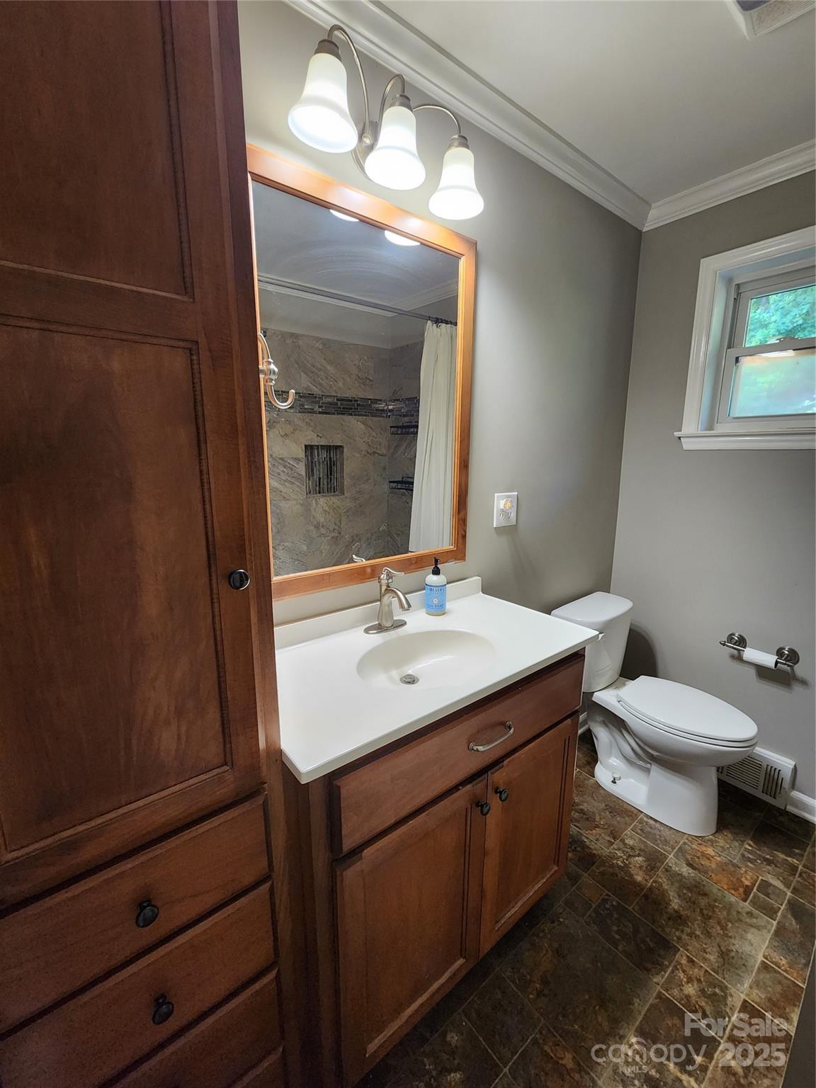 148 Palaside Drive Northeast Concord, NC 28025 - Photo 8 of 17 a bathroom with a toilet sink and mirror