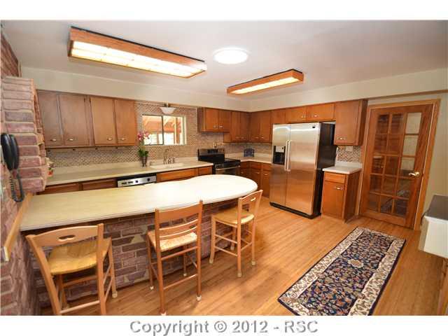 11685 Howells Road Colorado Springs, CO 80908 - Photo 4 of 16 ONE OF TWO KITCHENS ON THE MAIN LEVEL.