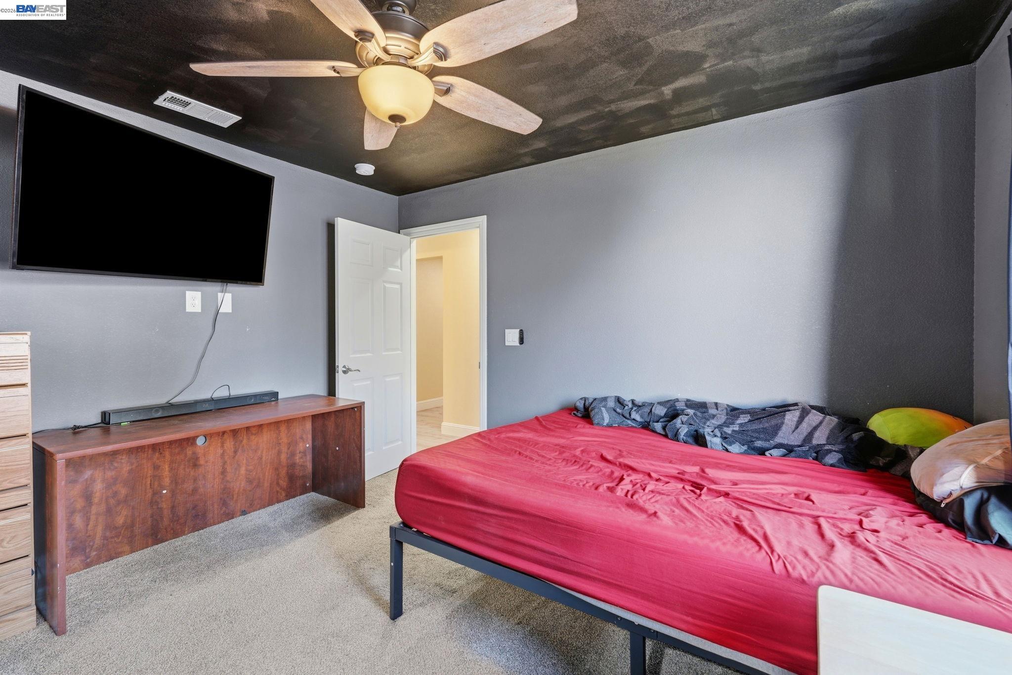 10378 South Priest Road French Camp, CA 95231 - Photo 14 of 44 a bedroom with a bed and a flat screen tv