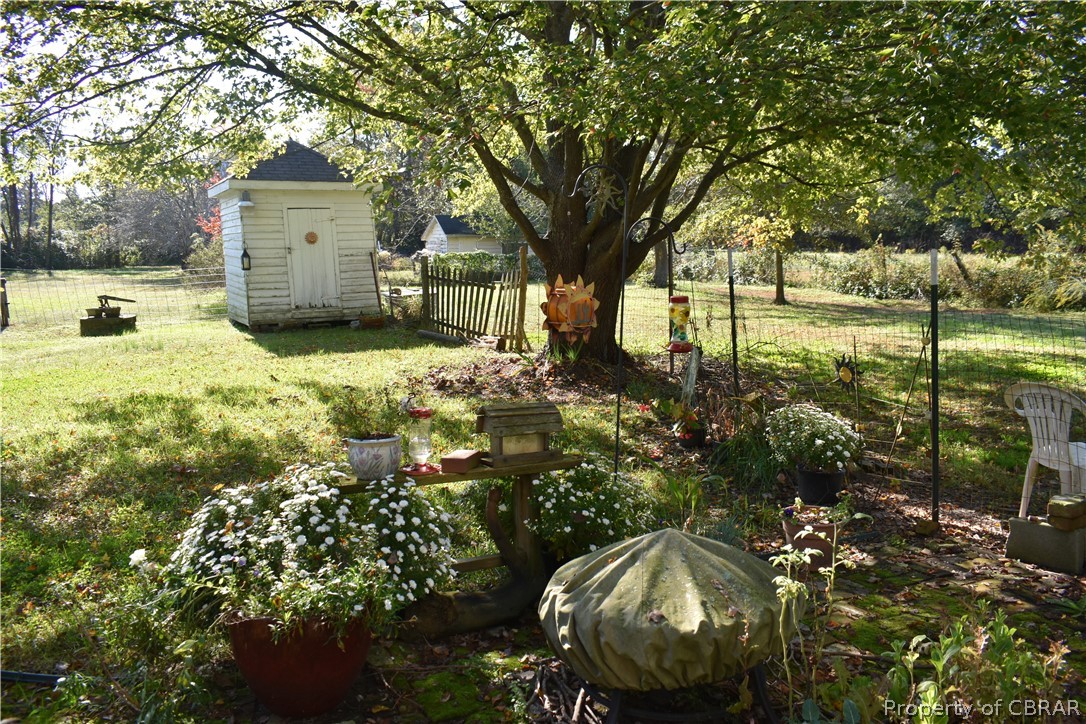 186 Aarons Bch Road Diggs, VA 23045 - Photo 30 of 40 View of yard, brick patio with beautiful maple tree and original outbuildings.