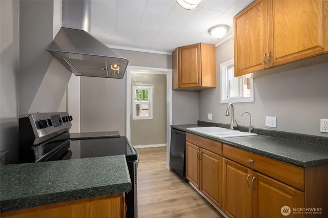a kitchen with a sink a stove and cabinets