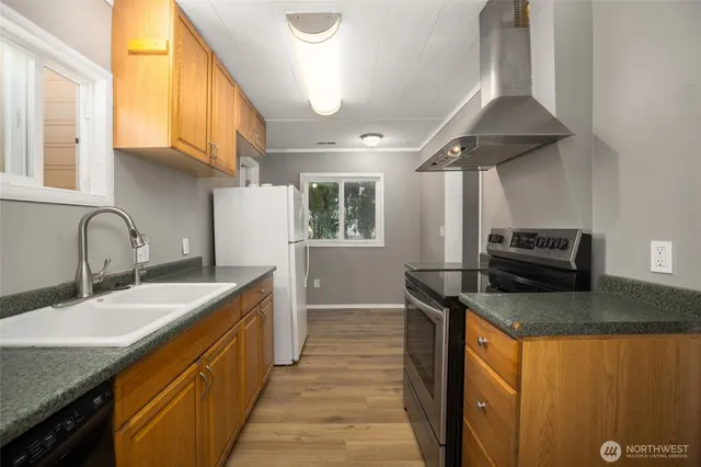 a kitchen that has a sink and a stove