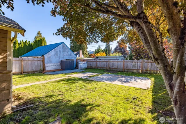 a view of backyard with swimming pool and small yard