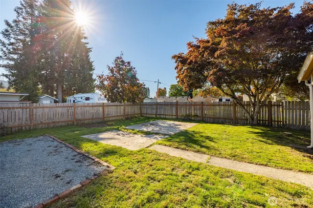 a view of backyard with wooden fence