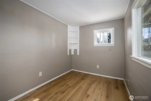 wooden floor in an empty room with a window
