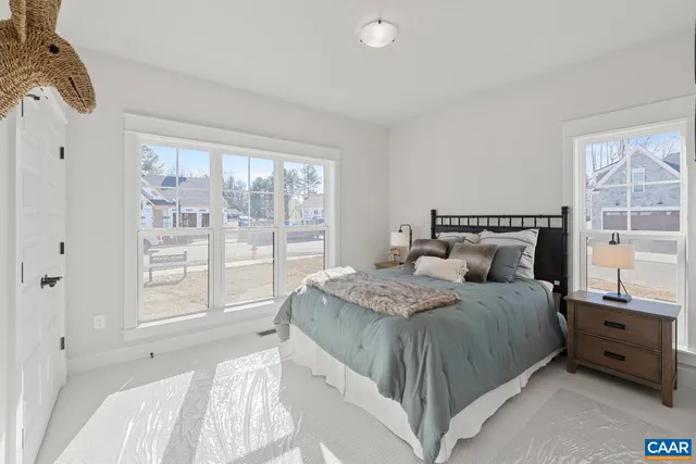a bedroom with a bed and large window