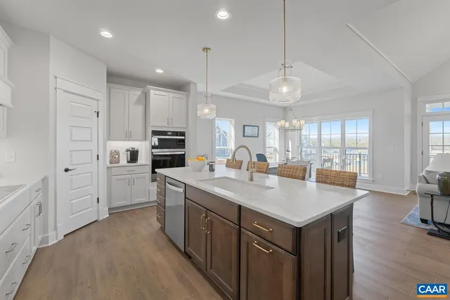a kitchen with sink stove and refrigerator