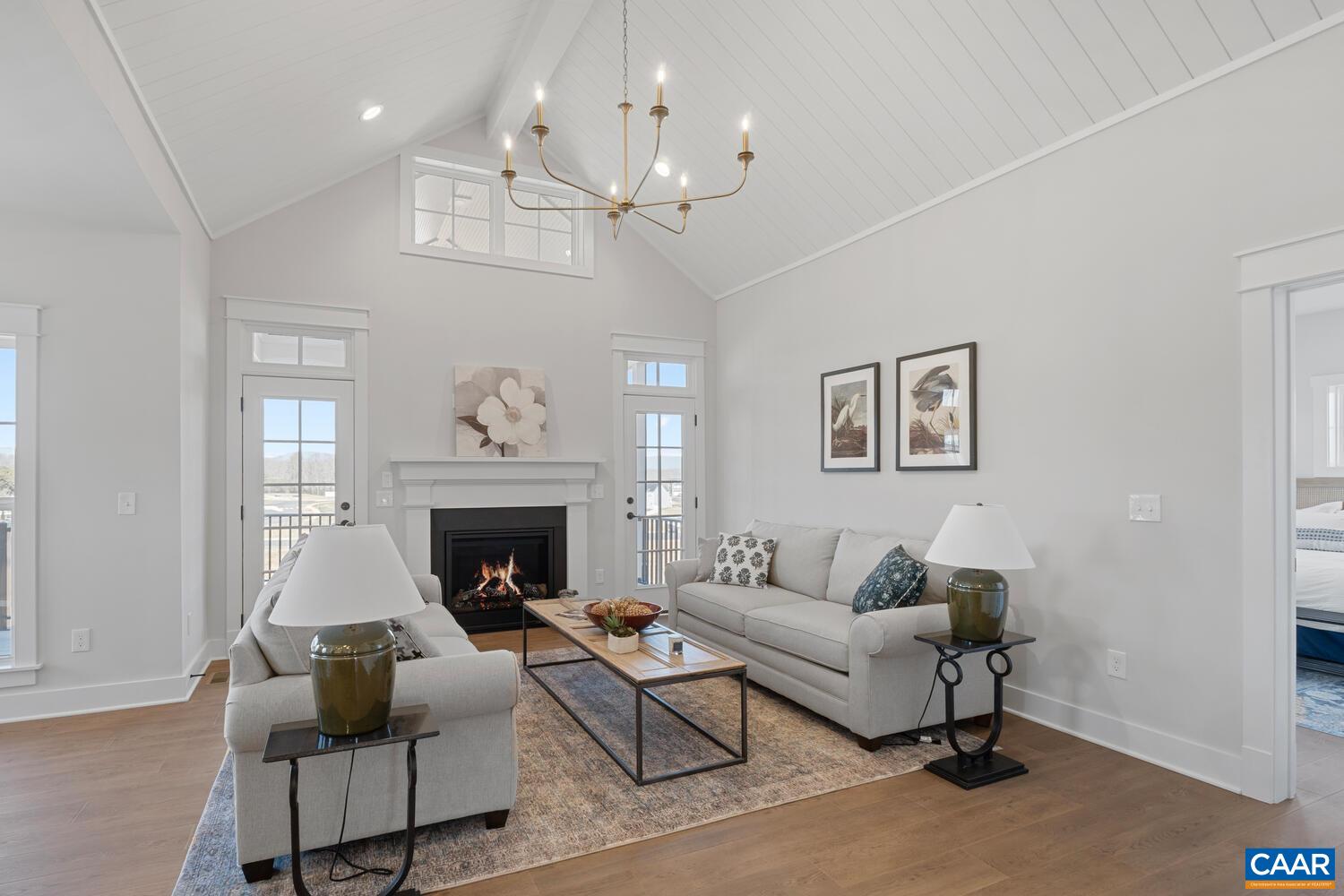 2 Agatha Ridge Lane, Unit C Crozet, VA 22932 - Photo 23 of 42 a living room with furniture a chandelier and a fireplace