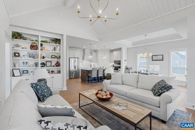 a living room with furniture a rug and a chandelier