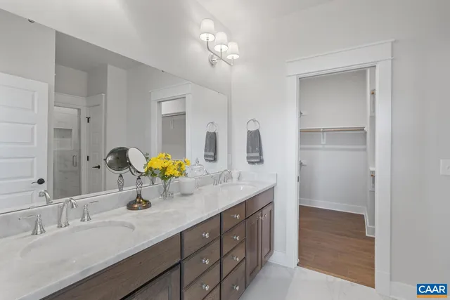 a bathroom with a double vanity sink and a mirror